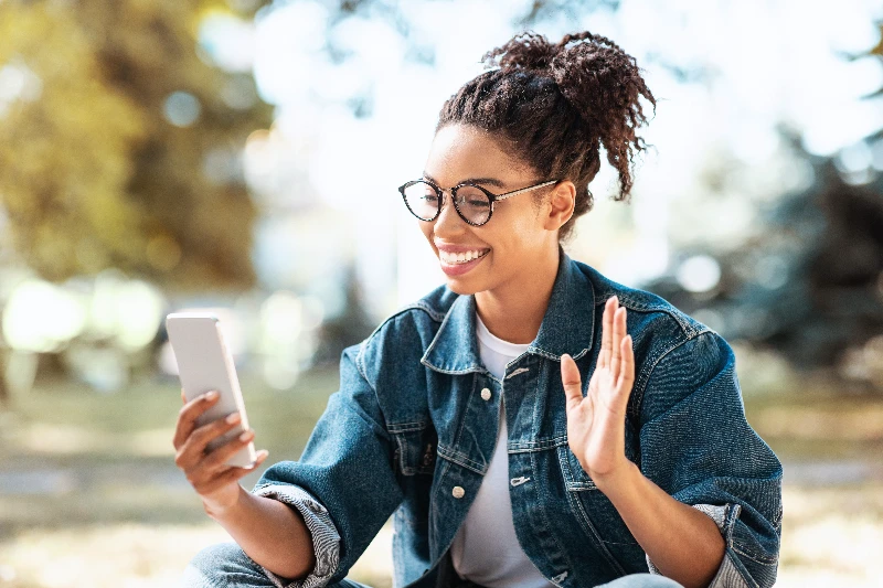 Happy woman using smartphone making video call